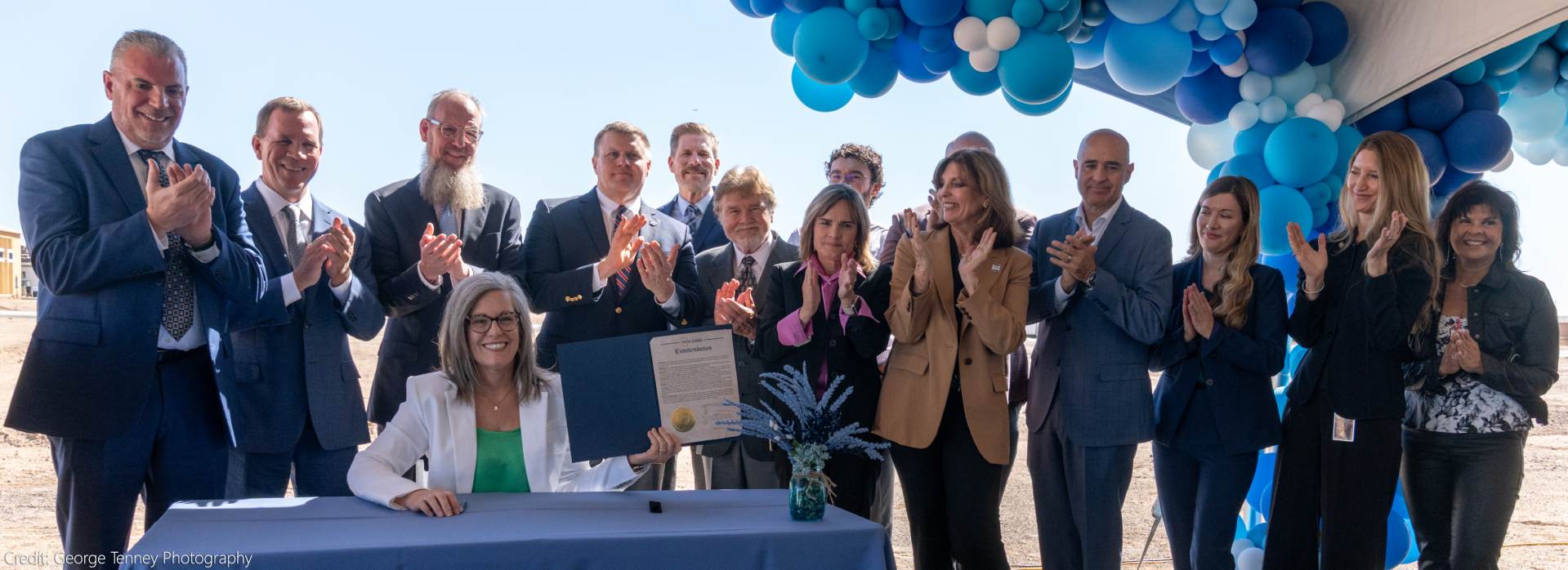 Arizona Department of Water Resources, Community Members, surround Gov Hobbs at a signing ceremony.