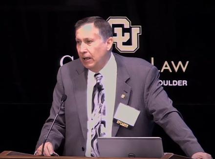 A Still of video of Director Buschatzke talking. 
